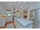 Bright kitchen with stainless appliances, white cabinetry, large island and views to the outside at 22 Fairhope Rd, Mount Pleasant, SC 29464