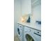 Bright laundry room with white countertop, cabinets, washer and dryer at 22 Fairhope Rd, Mount Pleasant, SC 29464