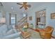 Bright living room featuring hardwood floors, a ceiling fan, and comfortable seating at 22 Fairhope Rd, Mount Pleasant, SC 29464