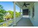 View from a covered porch with white columns and a ceiling fan overlooking lush landscaping at 22 Fairhope Rd, Mount Pleasant, SC 29464