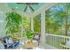 Inviting screened porch with wicker furniture, ceiling fan, and views of lush greenery at 22 Fairhope Rd, Mount Pleasant, SC 29464