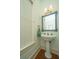Powder room with pedestal sink, decorative mirror and lighting at 22 Fairhope Rd, Mount Pleasant, SC 29464