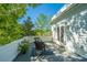 Charming rooftop patio with wicker seating, a small table, and views of mature trees and clear blue sky at 22 Fairhope Rd, Mount Pleasant, SC 29464