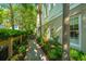 Inviting side yard with brick walkway, fence, lush landscaping and mature trees at 22 Fairhope Rd, Mount Pleasant, SC 29464