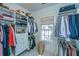 Organized walk-in closet with custom shelving, hanging rods, window and natural light at 22 Fairhope Rd, Mount Pleasant, SC 29464