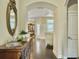 Elegant entryway featuring hardwood floors, an ornate mirror, and an arched doorway leading to the living areas at 222 Stone Village Cir, Summerville, SC 29486