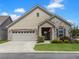Charming single-story home featuring stone accents, a two-car garage, and well-maintained landscaping at 222 Stone Village Cir, Summerville, SC 29486