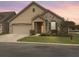 Attractive single-story home with stone and vinyl siding, showcasing a well-manicured lawn and covered entry at 222 Stone Village Cir, Summerville, SC 29486