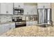 Bright kitchen with granite countertops, stainless steel appliances, and white cabinetry offering a fresh, modern aesthetic at 222 Stone Village Cir, Summerville, SC 29486