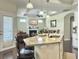 Open kitchen with granite countertops and breakfast bar overlooks a cozy living room with fireplace at 222 Stone Village Cir, Summerville, SC 29486