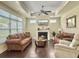 Comfortable living room features a fireplace, ceiling fan, and large window with ample natural light at 222 Stone Village Cir, Summerville, SC 29486