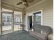 Screened in porch with chairs and ceiling fan at 222 Stone Village Cir, Summerville, SC 29486