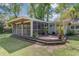 Spacious screened-in back porch, surrounded by lush landscaping and a stone-paved yard at 238 Howle Ave, Charleston, SC 29412