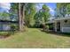 Expansive backyard featuring lush green grass, mature trees, and a detached garage at 238 Howle Ave, Charleston, SC 29412
