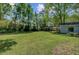 Large backyard with plenty of open space, a detached garage, and mature shade trees at 238 Howle Ave, Charleston, SC 29412