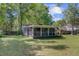 View of covered porch from a green lawn with trees providing shade and privacy at 238 Howle Ave, Charleston, SC 29412