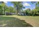 Spacious backyard showing house, screened porch, garage and mature trees at 238 Howle Ave, Charleston, SC 29412