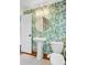 Stylish bathroom featuring tropical wallpaper, a pedestal sink, and a gold-trimmed round mirror at 238 Howle Ave, Charleston, SC 29412