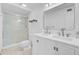 Modern bathroom features dual sinks, a glass-enclosed shower, and sleek white cabinetry at 238 Howle Ave, Charleston, SC 29412