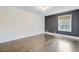 Spacious bedroom with hardwood floors, white and grey walls, and a bright window at 238 Howle Ave, Charleston, SC 29412