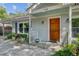 Inviting front entrance features a wood door, manicured landscaping, and charming details at 238 Howle Ave, Charleston, SC 29412