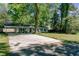 Charming home with a large front yard, a long driveway, and mature shade trees at 238 Howle Ave, Charleston, SC 29412