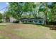 Traditional-style home showcasing beautiful curb appeal, a well-manicured lawn and mature trees at 238 Howle Ave, Charleston, SC 29412