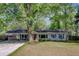 Charming single-story home with light gray siding, inviting front yard and mature trees at 238 Howle Ave, Charleston, SC 29412