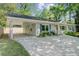 Charming single-story home featuring a covered carport, light gray siding and manicured landscaping at 238 Howle Ave, Charleston, SC 29412