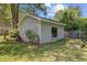 Detached garage with classic siding, a large window, and a small brick-lined garden at 238 Howle Ave, Charleston, SC 29412