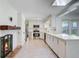 Bright kitchen showcases white cabinets, stainless steel appliances, and a charming brick fireplace at 238 Howle Ave, Charleston, SC 29412