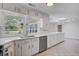 Bright kitchen showcasing white cabinets, stainless steel appliances, and a large window with backyard views at 238 Howle Ave, Charleston, SC 29412
