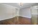 Open-concept living room with beautiful hardwood floors, stylish wallpaper and modern lighting at 238 Howle Ave, Charleston, SC 29412