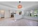 Open-concept living space features a decorative fireplace, tiled floors, and a seamless flow to the kitchen at 238 Howle Ave, Charleston, SC 29412