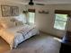 Cozy main bedroom features soft carpet, a ceiling fan, and dual windows for ample natural light at 238 Howle Ave, Charleston, SC 29412