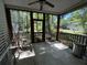 Relaxing screened porch with ceiling fan, offering a tranquil outdoor space at 241 Germantown Rd, Summerville, SC 29483