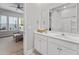 Bright bathroom featuring double sink vanity, a large mirror, and open access to bedroom at 245 Ribbon Rd, Summerville, SC 29483
