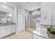 Bright bathroom featuring double sinks with granite countertops and a glass-enclosed shower with tile surround at 245 Ribbon Rd, Summerville, SC 29483