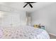 Bright bedroom features ceiling fan, closet, and colorful rainbow-themed bedding at 245 Ribbon Rd, Summerville, SC 29483