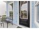 Charming front porch featuring a black door, a bench and a 'Welcome' mat, enhancing the entrance appeal at 245 Ribbon Rd, Summerville, SC 29483