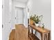 Inviting hallway featuring wood floors, neutral walls, and a stylish console table with plant accents at 245 Ribbon Rd, Summerville, SC 29483