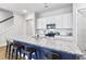 Close up of kitchen island with stone countertop and stylish bar stools and white cabinets at 245 Ribbon Rd, Summerville, SC 29483