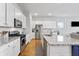 Modern kitchen with stainless steel appliances and large island with view to open living area at 245 Ribbon Rd, Summerville, SC 29483