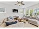 Bright and spacious living room featuring comfortable seating, a ceiling fan, and neutral decor at 245 Ribbon Rd, Summerville, SC 29483