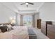 Spacious main bedroom featuring a tray ceiling, large windows, and stylish furniture at 245 Ribbon Rd, Summerville, SC 29483