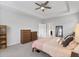 Bright main bedroom with gray walls featuring a ceiling fan, carpet floors, and wood furniture at 245 Ribbon Rd, Summerville, SC 29483