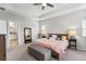 Bright main bedroom featuring a ceiling fan, a tray ceiling, carpet floors and a seating area at 245 Ribbon Rd, Summerville, SC 29483
