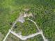 Wide aerial shot showcasing the property's access roads in a lush, green natural landscape at 254 Nelson Farm Ln, Cross, SC 29436
