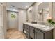 Bathroom featuring double sinks, modern fixtures, wood-look floors, and ample storage space at 254 Nelson Farm Ln, Cross, SC 29436
