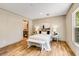 Inviting bedroom showcasing neutral walls, a decorative bed, and an ensuite bathroom with modern fixtures at 254 Nelson Farm Ln, Cross, SC 29436